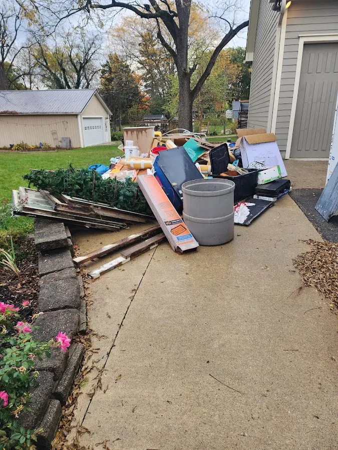 Dumpster being loaded with debris for Estate Cleanout Dumpster Rental in Niles